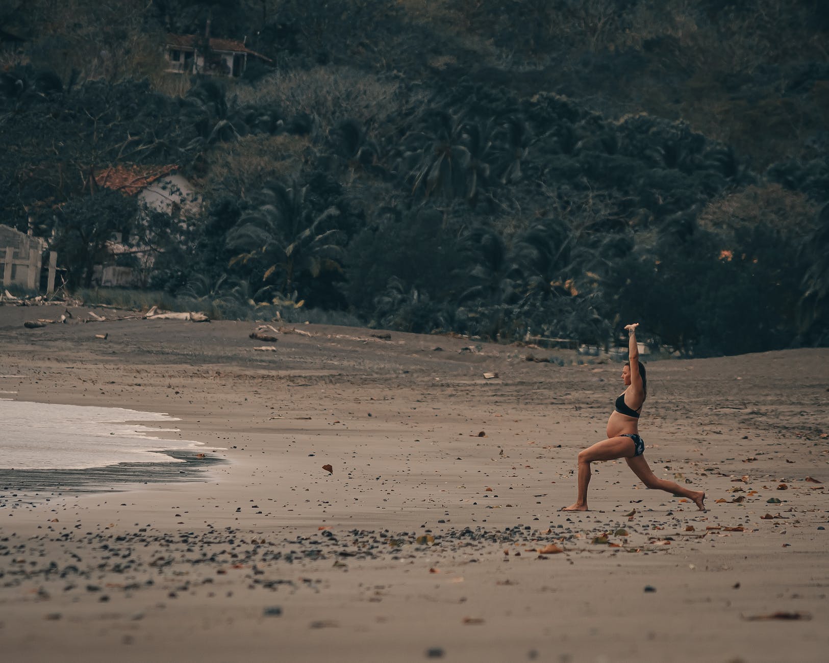 woman exercising on the beach