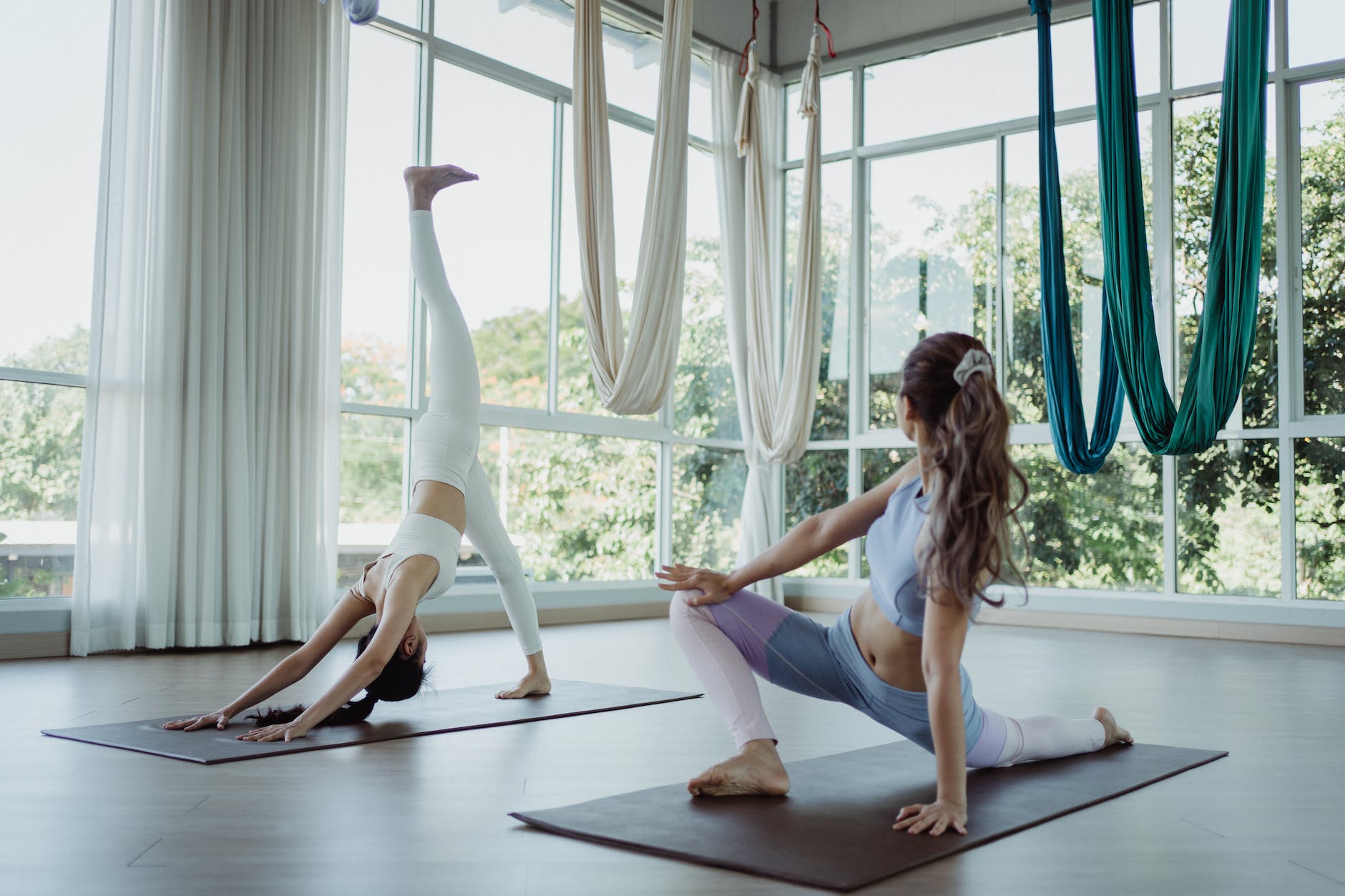 women wearing crop top and leggings practising yoga